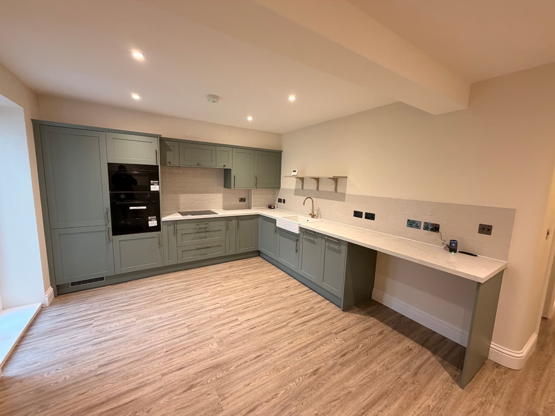 Sage green shaker style fitted kitchen