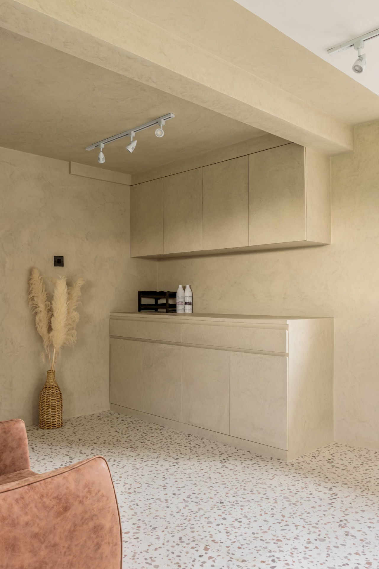 Fitted sideboard and wall cabinets in a limewashed room